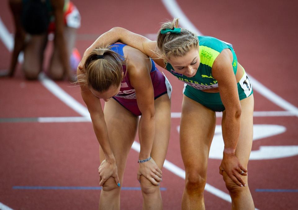 The USA's Sinclaire Johnson, left, and Australia's Jessica Hull recover after finishing sixth and seventh in the women's 1,500 meter final on day four of the World Athletics Championships at Hayward Field Monday, July 18, 2022.