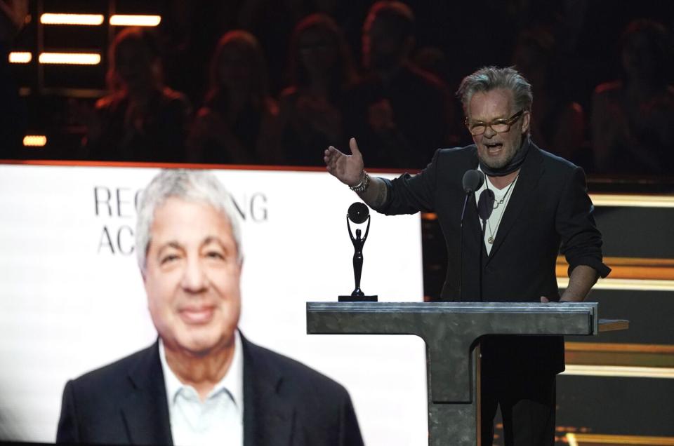 A man speaks in front of a podium