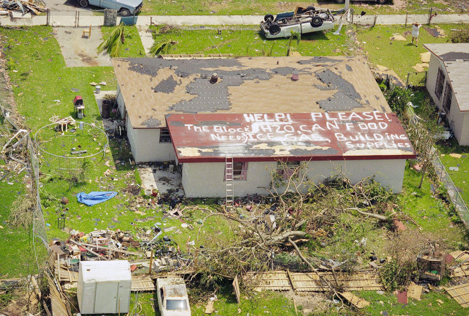 <p>A resident in Homestead, Fla., asks for help for the entire block, Aug. 26, 1992, after the area was ravaged by Hurricane Andrew earlier in the week. The sign on the roof reads “Help please! The block needs H20, can food, ice, gas, building supplies.” Homestead was one of the hardest hit areas in the wake of the storm. (AP Photo/Lynne Sladky) </p>