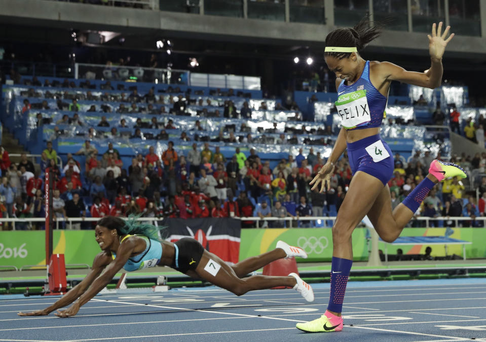 FILE - In this Aug. 15, 2016, file photo, Bahamas' Shaunae Miller-Uibo falls over the finish line to win gold ahead of United States' Allyson Felix, right, in the women's 400-meter final during the athletics competitions of the 2016 Summer Olympics at the Olympic stadium in Rio de Janeiro, Brazil. Miller-Uibo won gold in Rio with a dive at the finish of the 400 meters. She's diving in at the Tokyo Games with plans to not only defend her title but chase after gold in the 200 meters. (AP Photo/Matt Slocum, File)