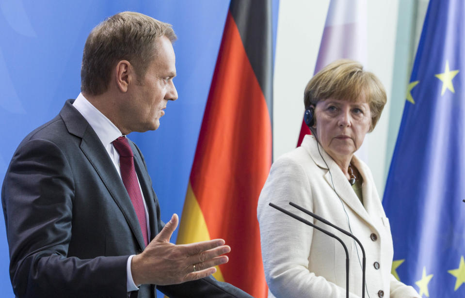 German Chancellor Angela Merkel, right, and Poland's Prime Minister Donald Tusk, left, address the media prior to talks likely to center on the situation in Ukraine at the Chancellery in Berlin, Germany, Friday, April 25, 2014. (AP Photo/Gero Breloer)