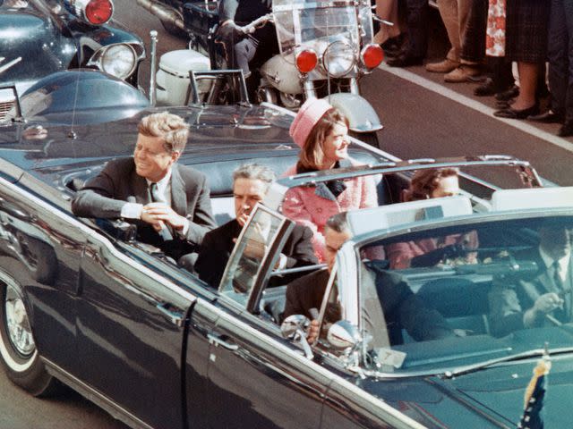 <p>Bettmann</p> US President John F Kennedy, First Lady Jacqueline Kennedy, Texas Governor John Connally, and others smile at the crowds lining their motorcade route in Dallas, Texas, on November 22, 1963.