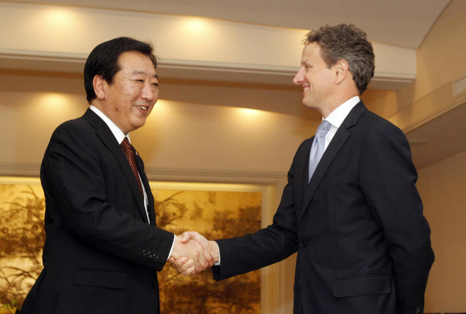 CORRECTS FIRST NAME OF NODA - Japan's Prime Minister Yoshihiko Noda, left, and U.S. Treasury Secretary Timothy Geithner shake hands as they meet on the sidelines of the annual meetings of the IMF and the World Bank Group in Tokyo, Friday, Oct. 12, 2012. (AP Photo/Yuriko Nakao, Pool)