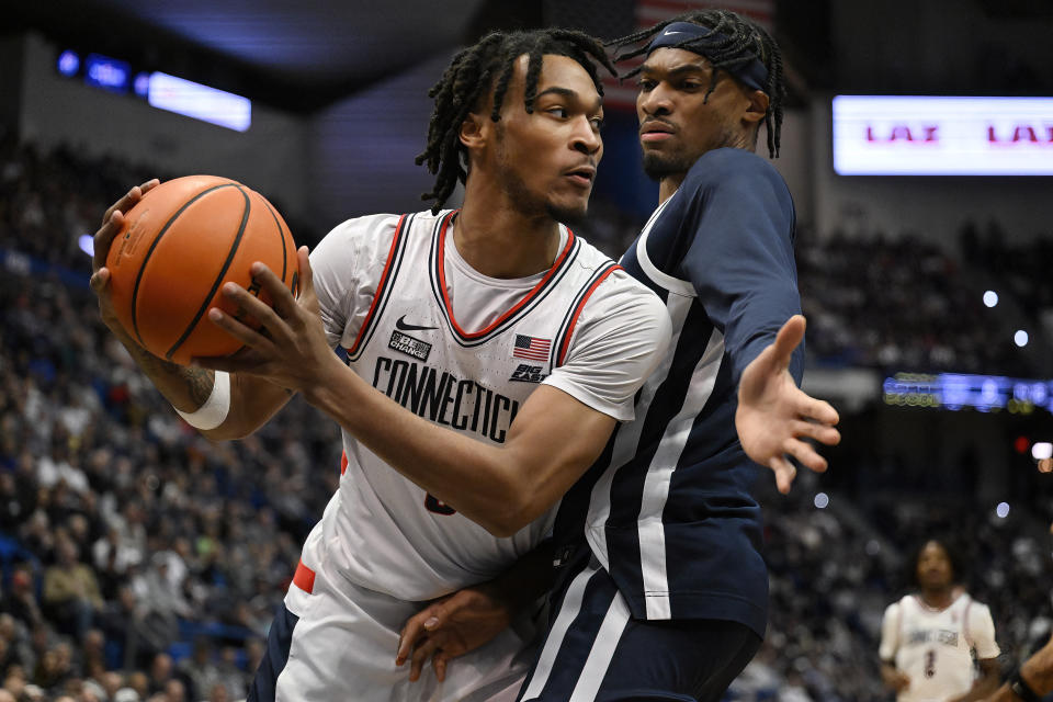 UConn guard Stephon Castle, left, is guarded by Butler forward Jalen Thomas in the first half of an NCAA college basketball game, Tuesday, Feb. 6, 2024, in Hartford, Conn. (AP Photo/Jessica Hill)