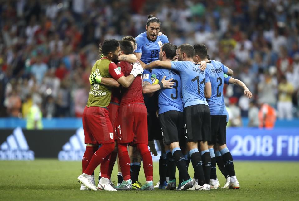 <p>Uruguay celebrate at the final whistle after their 2-1 win over Portugal in Sochi </p>