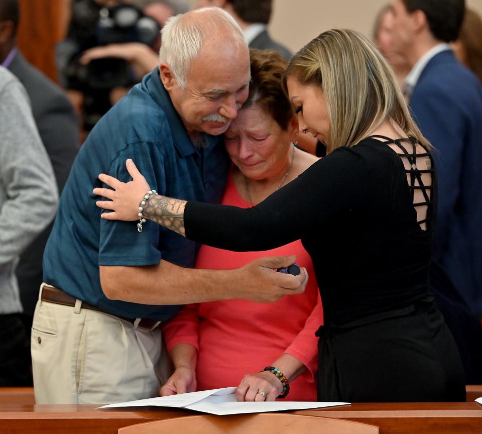 Edward and Beth Dabrowski hug their daughter Victoria after the conclusion of the trial of Carlos Asencio who was convicted of first degree murder in the death of their daughter Amanda.