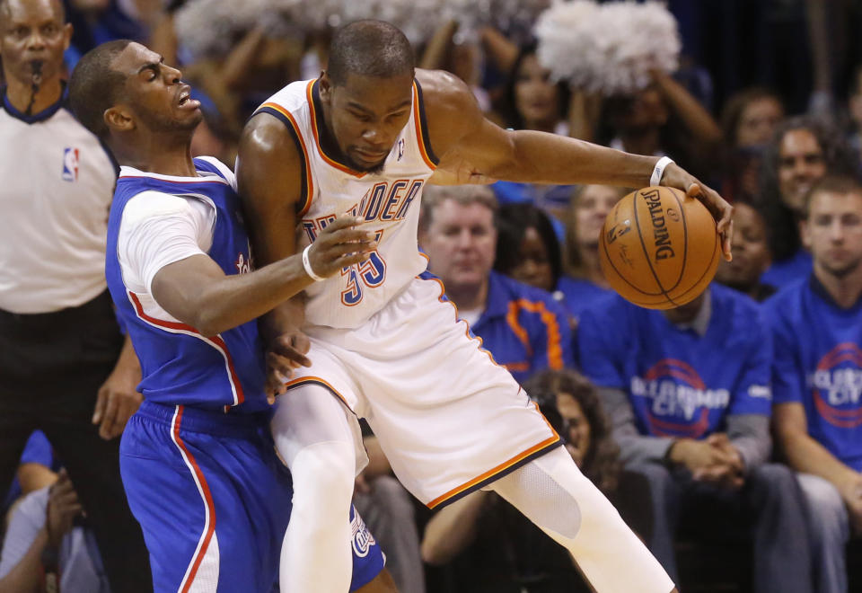 Oklahoma City Thunder forward Kevin Durant, right, drives against Los Angeles Clippers guard Chris Paul, left, in the second quarter of Game 1 of the Western Conference semifinal NBA basketball playoff series in Oklahoma City, Monday, May 5, 2014. (AP Photo/Sue Ogrocki)