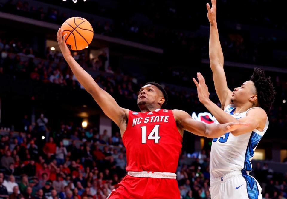 N.C. State’s Casey Morsell (14) drives to the basket past Creighton’s Trey Alexander (23) during the first half of N.C. State’s game against Creighton in the first round of the NCAA Tournament at Ball Arena in Denver, Colo., Friday, March 17, 2023. Ethan Hyman/ehyman@newsobserver.com