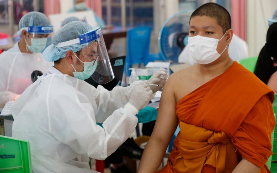 A health worker injects a Buddhist monk with dose of the Sinovac COVID-19 vaccine in Bangkok, Thailand -  Sakchai Lalit / AP