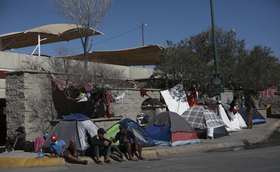 Migrants camp just outside the immigration detention center where a dormitory fire killed more than three dozen people, in Ciudad Juarez, Mexico, Thursday, April 20, 2023. (AP Photo/Christian Chavez)