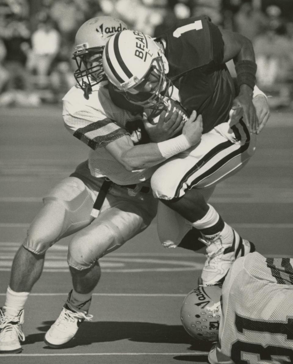 Bears quarterback DeAndre Smith is tackled by an Idaho defender on November 24, 1990.