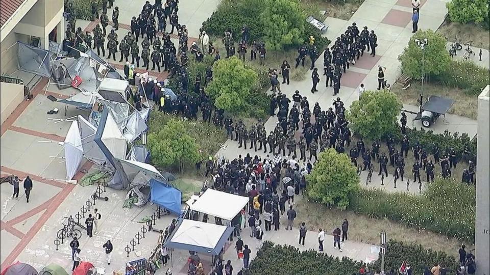 PHOTO: In this screen grab from a video, pro-Palestinian demonstrators stand in front of a line of police as they clear an encampment at the University of California, Irvine, in Irvine, Calif., on May 15, 2025.  (KABC)