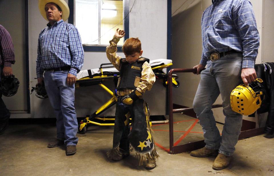 Avery Speck, 8, practices holding on before competing in the mini bull riding competition at the 108th National Western Stock Show in Denver January 11, 2014. The show, which features more than 15,000 head of livestock, opened on Saturday and runs through January 26. REUTERS/Rick Wilking (UNITED STATES - Tags: ANIMALS SOCIETY TPX IMAGES OF THE DAY)