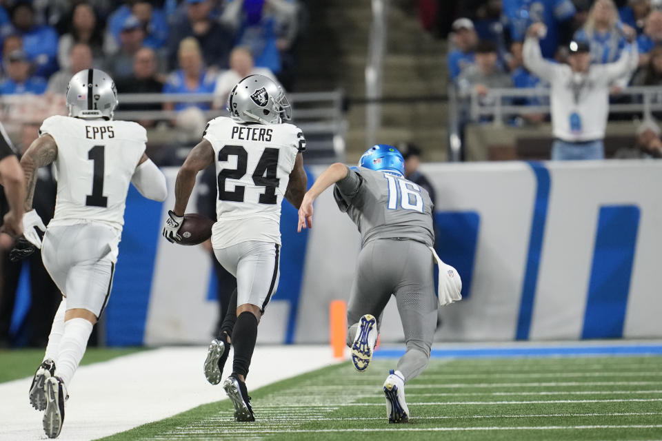 Las Vegas Raiders cornerback Marcus Peters (24) returns an intercepted pass from Detroit Lions quarterback Jared Goff (16) for a touchdown during the second half of an NFL football game, Monday, Oct. 30, 2023, in Detroit. (AP Photo/Paul Sancya)