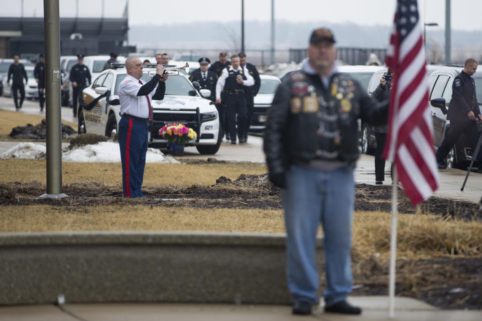 Taps is performed as people arrive before funeral services for slain McHenry County Sheriff's Deputy Jacob Keltner on Wednesday, March 13, 2019, at Woodstock North High School in Woodstock, Ill. Keltner was shot and killed while trying to serve an arrest warrant at a hotel on March 7, 2019. (Scott P. Yates/Rockford Register Star via AP)