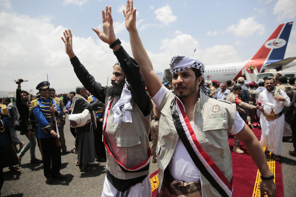 Houthi prisoners cheers as they arrive to Sanaa airport, Friday, April 14, 2023. An exchange of more than 800 prisoners linked to Yemen's long-running war them began Friday, the International Committee for the Red Cross said. The three-day operations will see flights transport prisoners between Saudi Arabia and Yemen's capital, Sanaa, long held by the Iranian-backed Houthi rebels. ((AP Photo/Hani Mohammed)