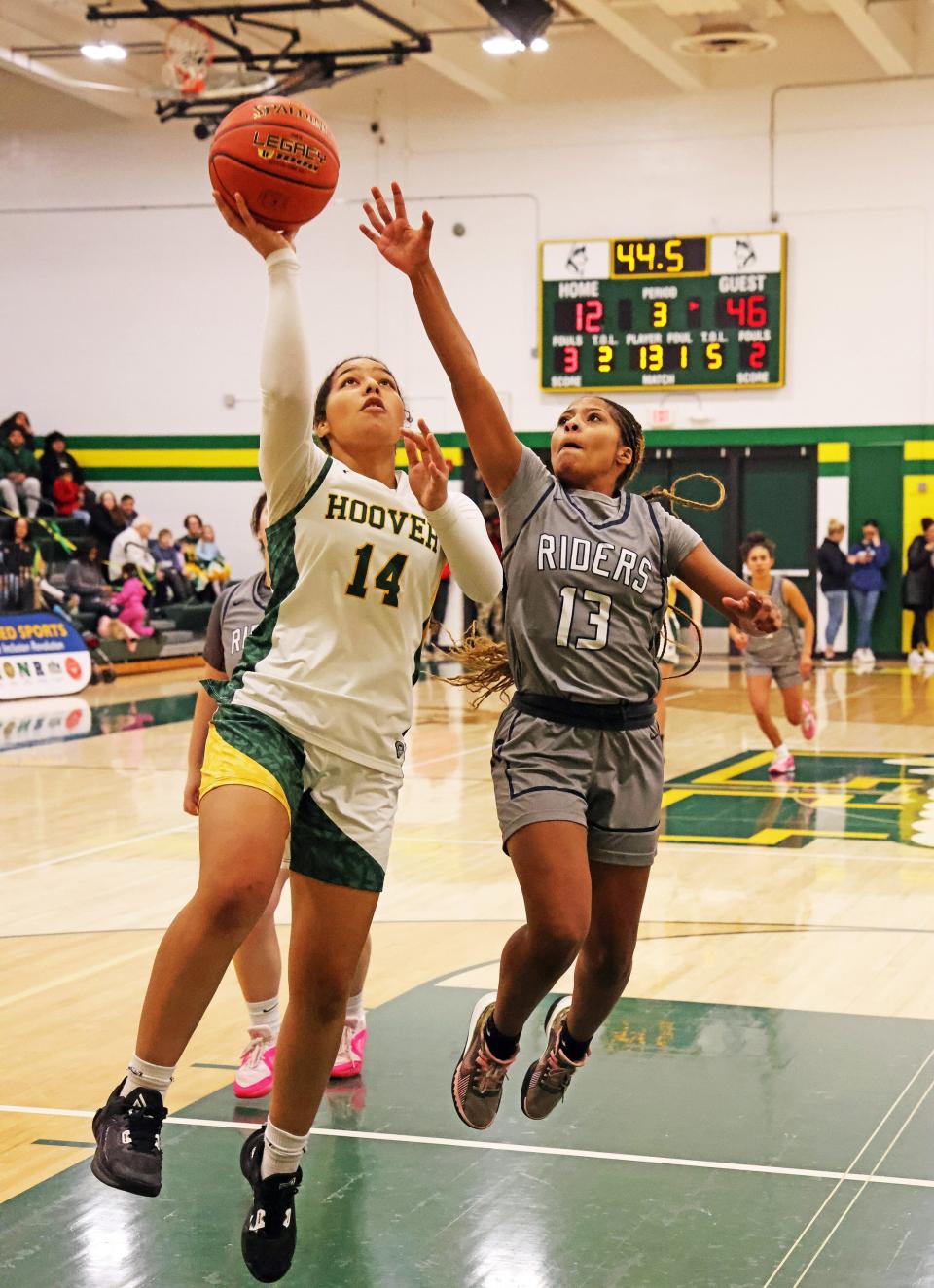 Hoover senior guard Alayna Jarrett (14) drives past Roosevelt sophomore Keonni Langford (13). Hoover fell to 0-10 on the season after Friday's loss.