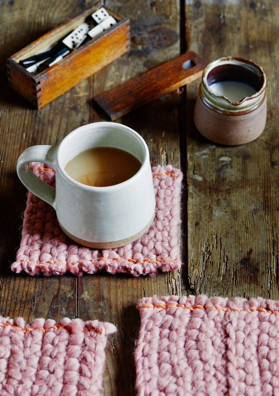 a cup of tea on a saucer next to a napkin and a book