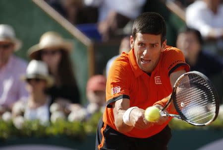 Novak Djokovic of Serbia returns the ball to Stan Wawrinka of Switzerland during their men's final match at the French Open tennis tournament at the Roland Garros stadium in Paris, France, June 7, 2015. REUTERS/Vincent Kessler