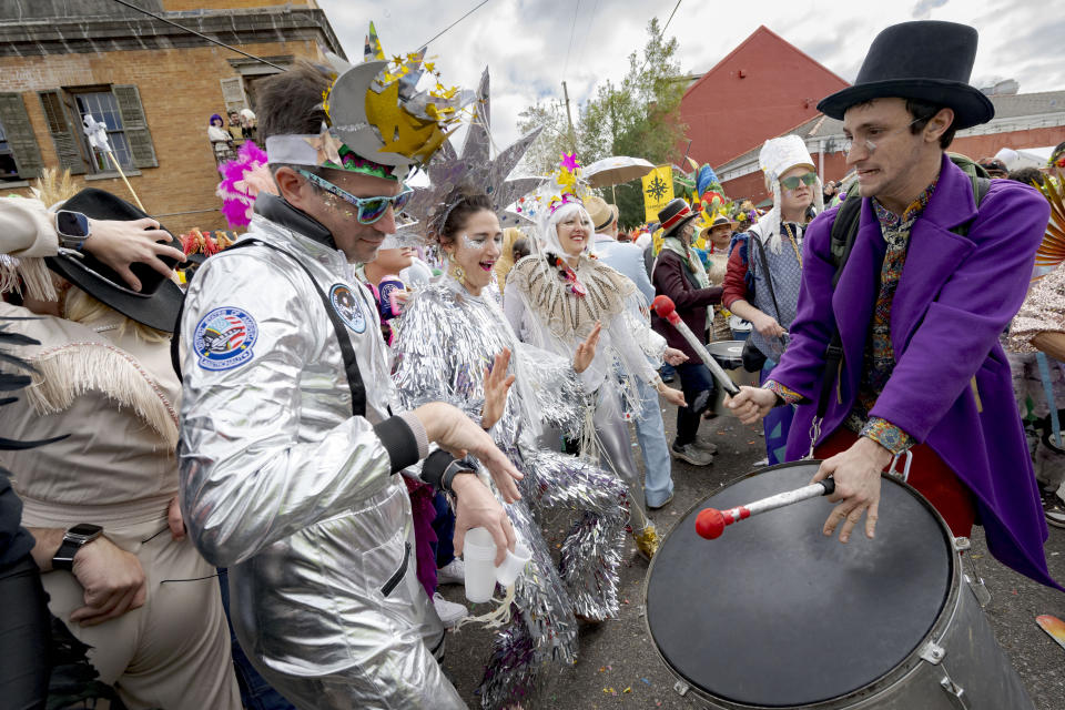 People dance in costumes during the Society of Saint Anne parade through Bywater and Marigny neighborhoods on Mardi Gras Day in New Orleans, Tuesday, Feb. 13, 2024. (AP Photo/Matthew Hinton)