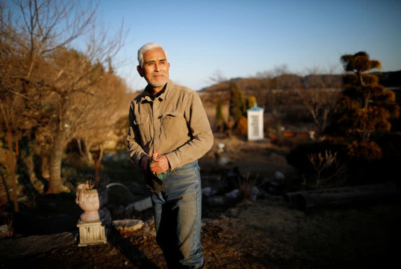 The Wider Image: Japan's tsunami survivors call lost loves on the phone of the wind