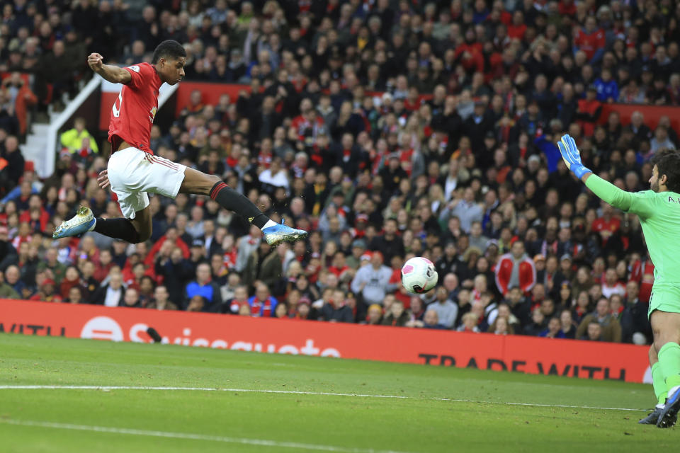 Manchester United's Marcus Rashford scores his side's opening goal during the English Premier League soccer match between Manchester United and Liverpool at the Old Trafford stadium in Manchester, England, Sunday, Oct. 20, 2019. (AP Photo/Jon Super)