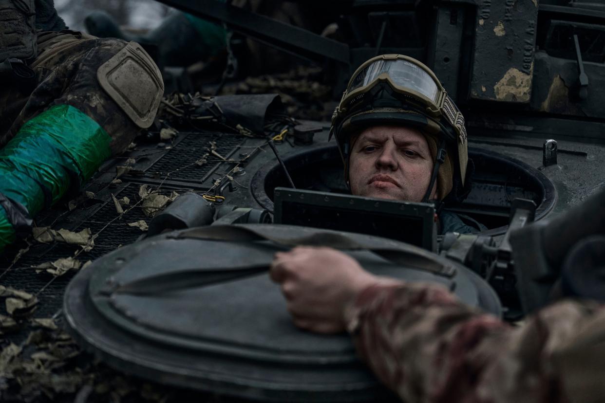 A Ukrainian soldier looks out of the APC on the frontline in Bakhmut, Donetsk region (AP)