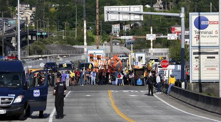 Activists march and rally at the entrance of Terminal 5 to protest Shell Oil Company's drilling rig Polar Pioneer which is parked at the Port of Seattle, Washington May 18, 2015. REUTERS/Jason Redmond