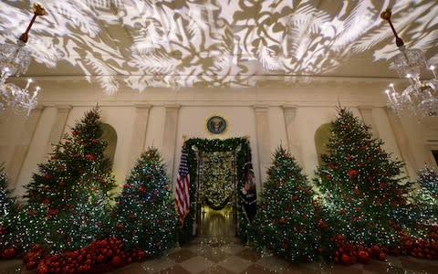 14,000 red ornaments hanging on 29 trees in the Grand Foyer - Credit: Carolyn Kaster/AP