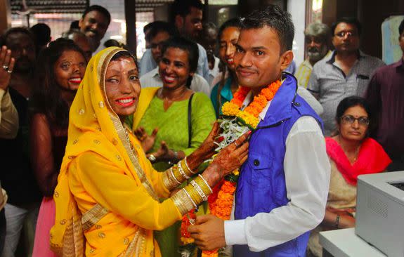 Lalita Ben Bansi and Ravi Shankar exchange flower garlands as part of a traditional Hindu ceremony.