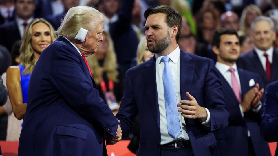 PHOTO: Former U.S. President Donald Trump greets Republican vice-presidential nominee JD Vance as he attends Day 1 of the Republican National Convention, in Milwaukee, July 15, 2024.  (Andrew Kelly/Reuters)