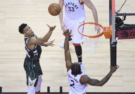 May 21, 2019; Toronto, Ontario, CAN; Milwaukee Bucks forward Giannis Antetokounmpo (34) shoots the ball over Toronto Raptors forward Kawhi Leonard (2) during the fourth quarter in game four of the Eastern conference finals of the 2019 NBA Playoffs at Scotiabank Arena. Mandatory Credit: Nick Turchiaro-USA TODAY Sports