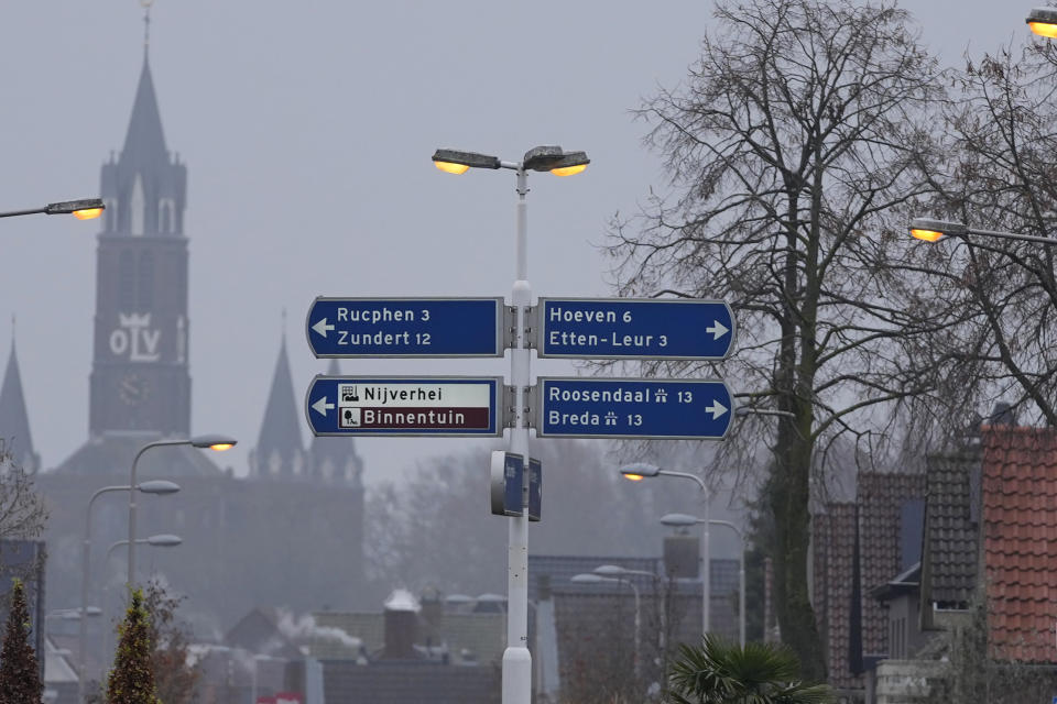 The church of Sint Willesbrord, Netherlands, serves as a backdrop for street signs at a roundabout on Friday, Dec. 1, 2023. In the quiet Dutch village of Sint Willebrord, nearly three out of four voters chose a virulently anti-migrant, anti-Muslim party in an election last year that shattered the Netherlands' image as a welcoming, moderate country. Analysts say far-right parties are primed to gain influence over EU policies affecting everything from civil rights to gender issues to immigration. (AP Photo/Virginia Mayo)