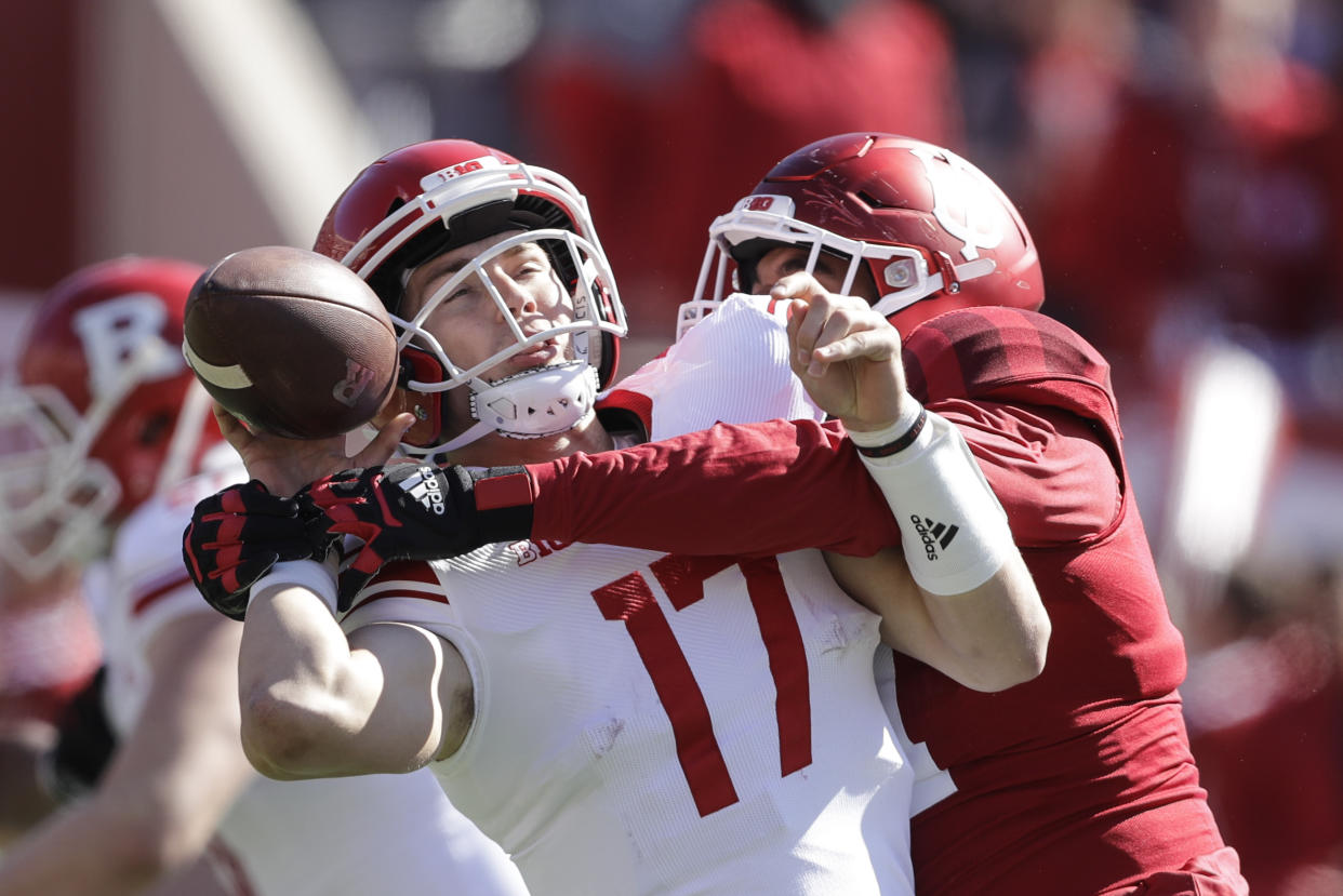 Rutgers quarterback Johnny Langan (17) fumbles as he is hit by Indiana defensive lineman Demarcus Elliott (94) during the first half of an NCAA college football game, Saturday, Oct. 12, 2019, in Bloomington, Ind. (AP Photo/Darron Cummings)