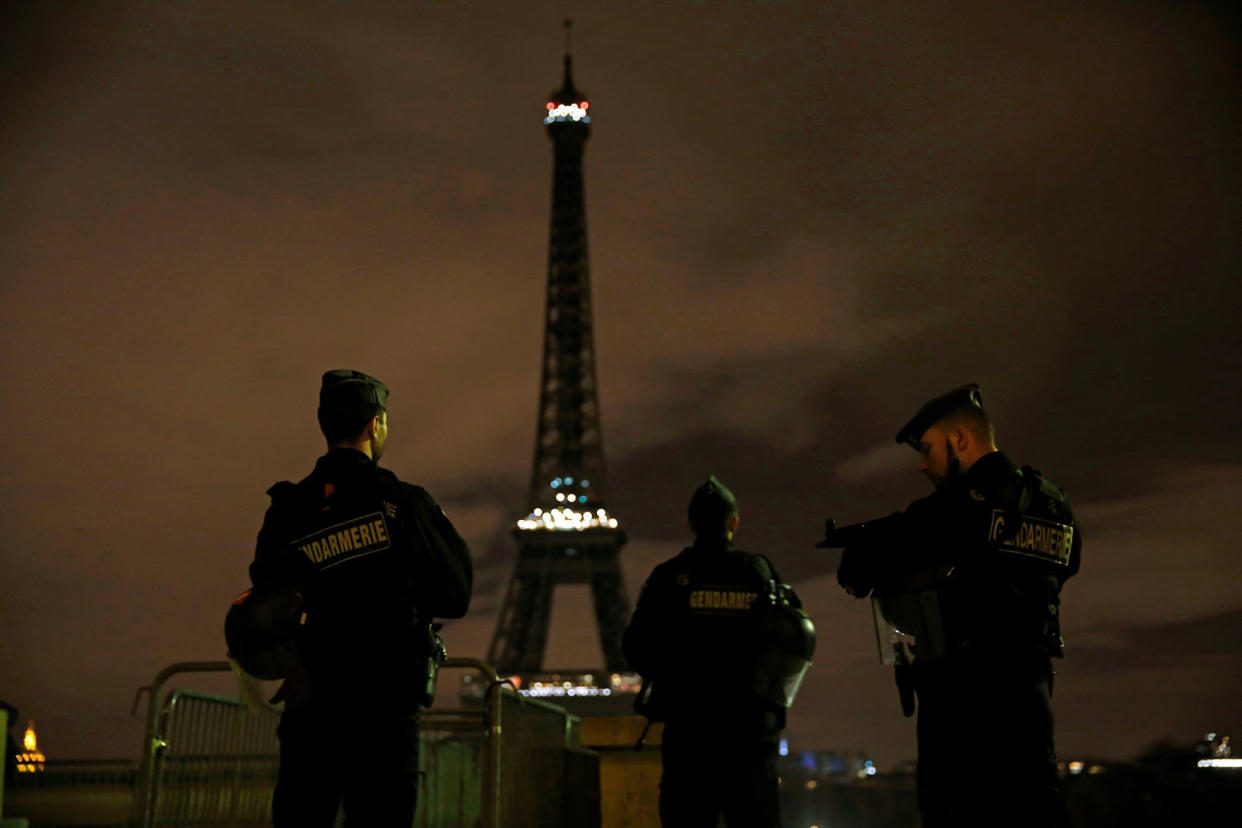 Armed police stand guard overlooking the Eiffel Tower (Carolyn Cole / Los Angeles Times via Getty Images file)