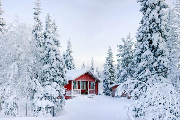 Winter's Tale. Red Finnish cottage in a beautiful snow forest.