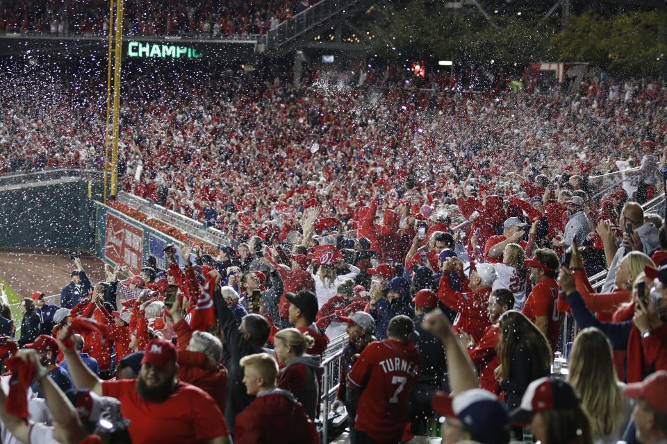 Washington Nationals fans celebrate after Game 4 of the baseball National League Championship Series against the St. Louis Cardinals Wednesday, Oct. 16, 2019, in Washington. The Nationals won 7-4 to win the series 4-0. (AP Photo/Alex Brandon)