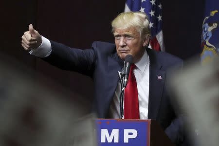 U.S. Republican presidential candidate Donald Trump speaks on stage during campaign event at Grumman Studios in Bethpage, New York April 6, 2016 REUTERS/Carlo Allegri