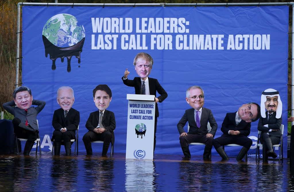 A replica of the Cop26 summit’s main UN negotiation stage, carrying activists dressed as world leaders (Andrew Milligan/PA) (PA Wire)