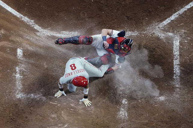 Philadelphia Phillies' Nick Castellanos (8) is tagged out by Atlanta Braves catcher Sean Murphy during the seventh inning of a baseball game Thursday, May 25, 2023, in Atlanta. (AP Photo/John Bazemore)