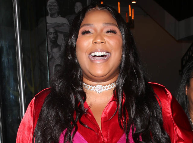 Lizzo Goes Bold in Red Silk Blouse With Pink Bra Detail, Wide-Leg