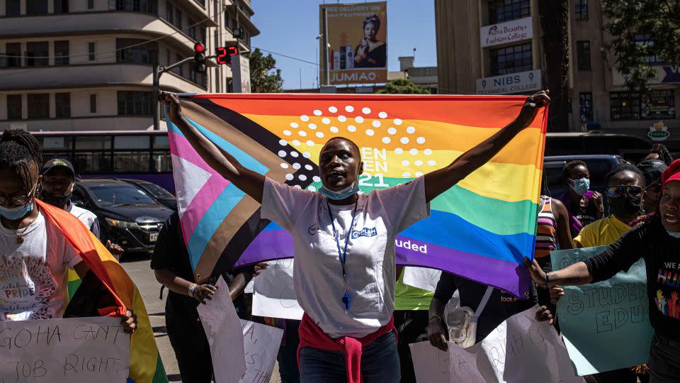 A woman holds a pride flag during a protest organized by The Queer Republic in Nairobi in January 2022. - Patrick Meinhardt/AFP/Getty Images