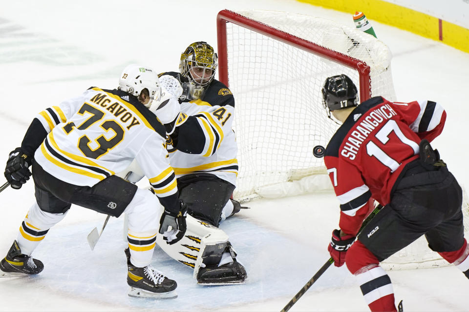 Boston Bruins goaltender Jaroslav Halak (41) looks over his shoulder as New Jersey Devils center Yegor Sharangovich (17) looks into the net at New Jersey Devils center Pavel Zacha's game-winning overtime goal in an NHL hockey game, Tuesday, May 4, 2021, in Newark, N.J.(AP Photo/Kathy Willens)