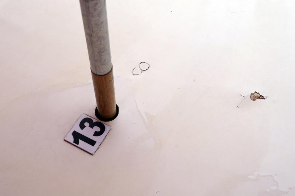 A bullet hole pierces table 13, the table that was next to the table where four doctors were sitting when they were shot at the food and bar kiosk "Nana 2" on the beach in the Barra de Tijuca neighborhood of Rio de Janeiro, Brazil, Thursday, Oct. 5, 2023. Three of the doctors died in the overnight shooting. (AP Photo/Silvia Izquierdo)