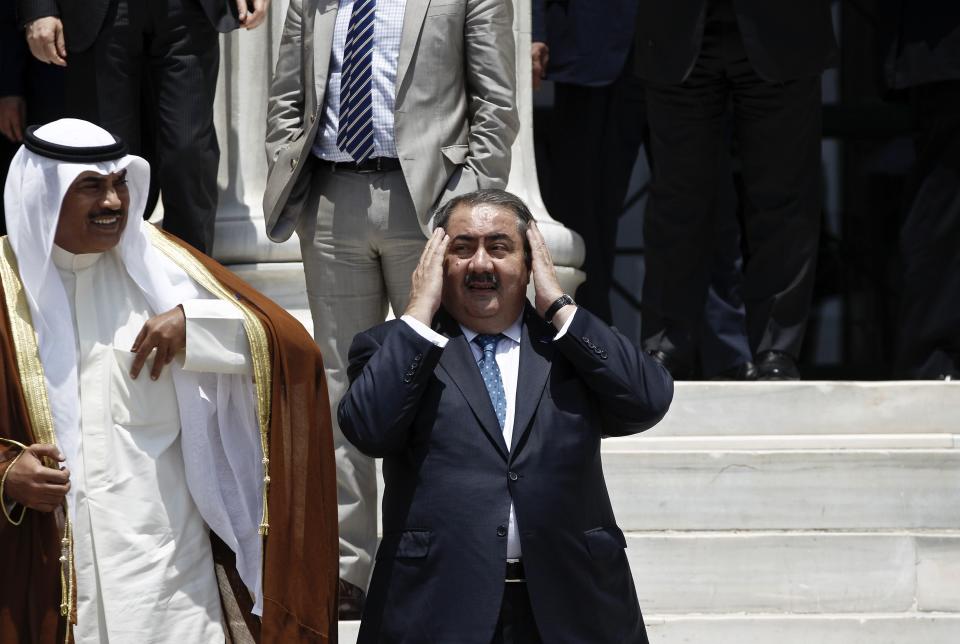 Iraqi Foreign Minister Hoshyar Zebari (C) prepares himself for a family photo during an EU-Arab league summit in Athens June 11, 2014. Baghdad will cooperate with Kurdish forces to try to drive militant out of Mosul, Iraq's foreign minister said on Wednesday, a day after an al Qaeda splinter group seized the country's second biggest city. REUTERS/Alkis Konstantinidis (GREECE - Tags: POLITICS)