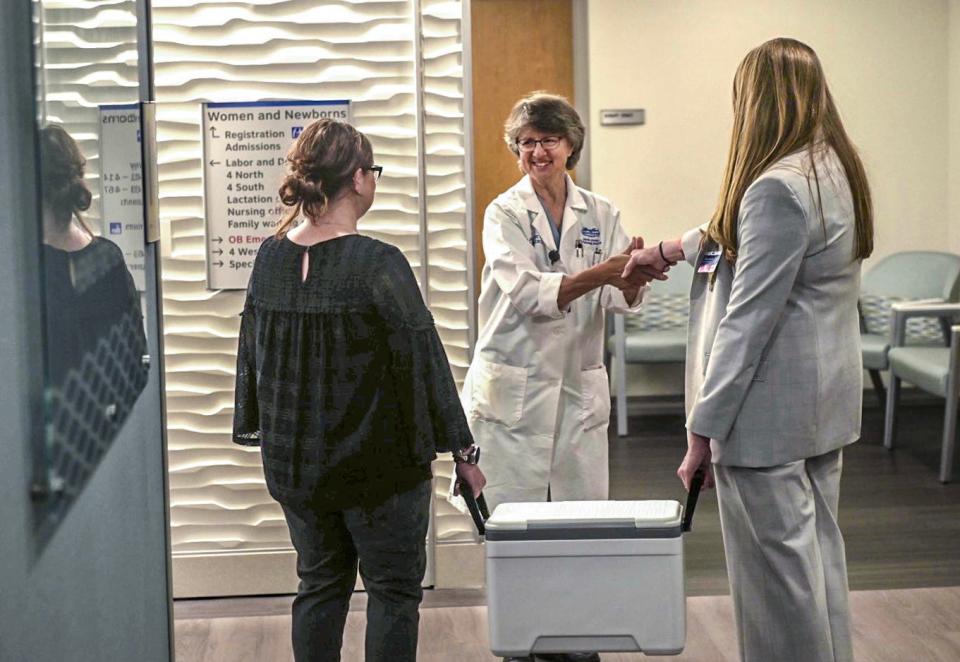 Henry Ford Jackson staff deliver their first batch of safe, pasteurized human donor breast milk to Henry Ford Jackson Hospital's special care nursery. The milk is received by lactation consultant Janine Hatt.