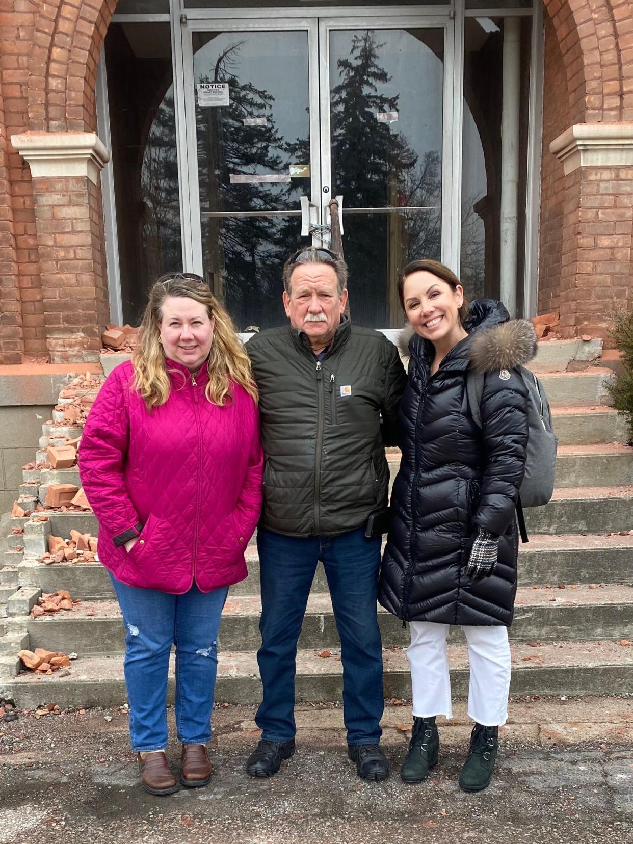 Leslie Harkai (left), curator of historical collections for the Flat Rock Historical Society; Bruce Chapin, president of the historical society; and Jennifer Schoenberger, owner of a design firm in Georgia who grew up in Flat Rock, are pictured in front of the Reading Building.