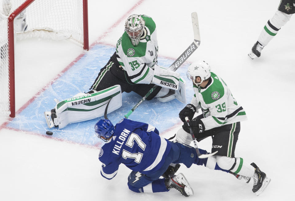 Dallas Stars goaltender Anton Khudobin (35) makes a save against Tampa Bay Lightning center Alex Killorn (17) as Dallas Stars defenseman Joel Hanley (39) defends during third-period NHL Stanley Cup finals hockey action in Edmonton, Alberta, Saturday, Sept. 19, 2020. (Jason Franson/The Canadian Press via AP)