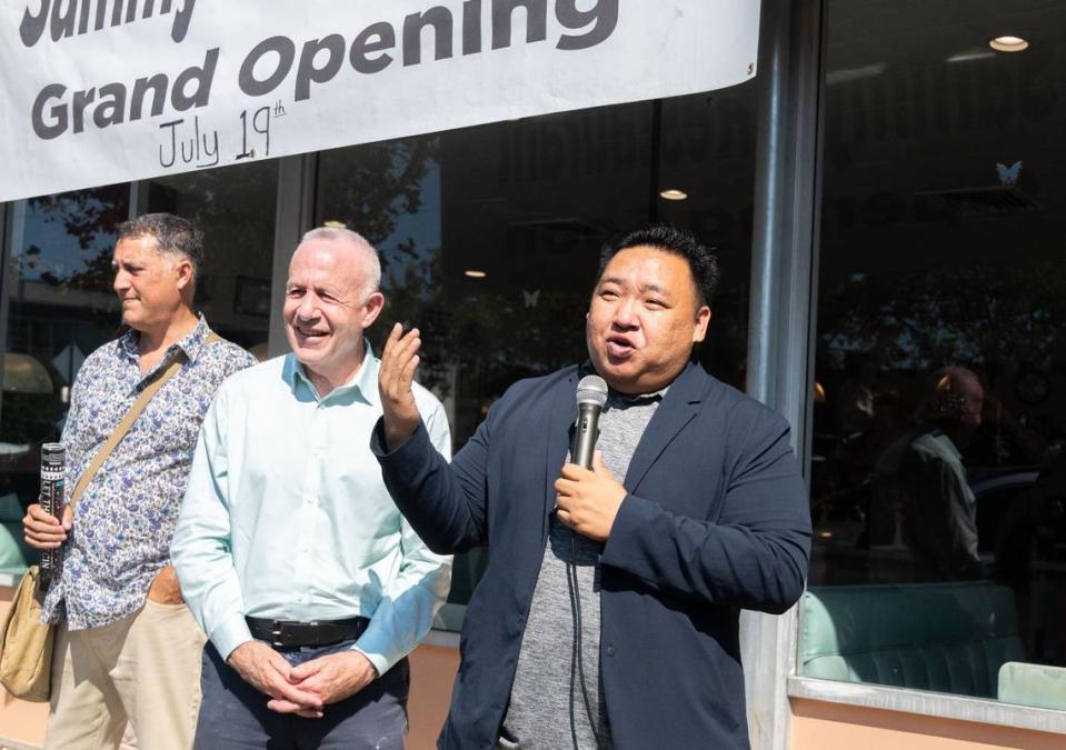 Sacramento Councilman Shoun Thao, right, standing with Mayor Darrell Steinberg, speaks to a crowd gathered to celebrate the grand reopening of Sammy’s Restaurant in North Sacramento on Friday. Thao said the business, which first opened in 1944, is part of the economic revitalization in the Del Paso Boulevard and Marysville Boulevard business corridor.