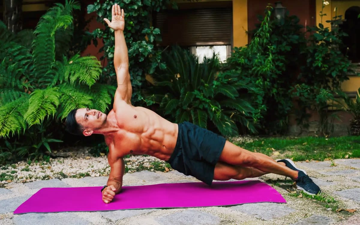  A photo of a man performing a side plank. 